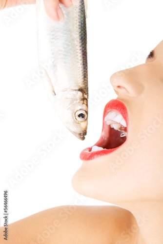 Photo: Beautiful young woman with raw fish Beautiful young woman with raw fish