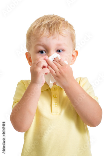 Photo: kid cleaning nose with tissue isolated on white kid cleaning nose with tissue isolated on white