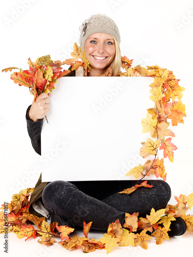 Photo: Woman with message board in autumn Woman with message board in autumn