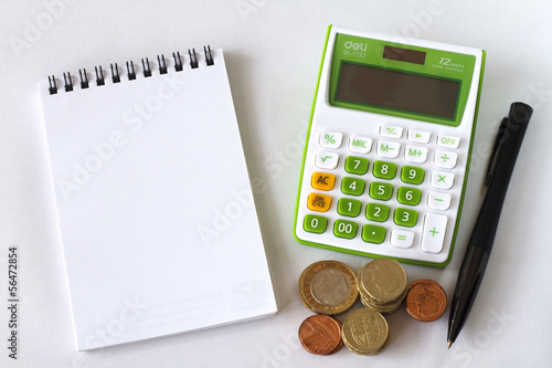 Photo: Calculator Notebook and Pen on White Background. Calculator Notebook and Pen on White Background.