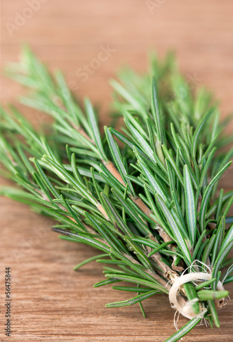 Photo: Bunch of rosemary on a rustic wood Bunch of rosemary on a rustic wood