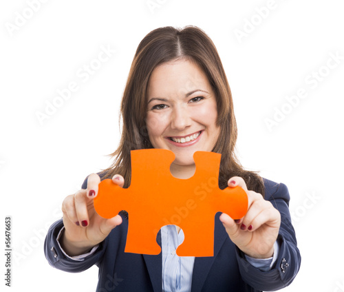 Photo: Business woman holding a puzzle piece Business woman holding a puzzle piece