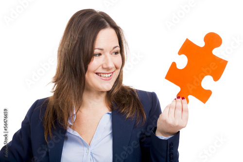 Photo: Business woman holding a puzzle piece Business woman holding a puzzle piece