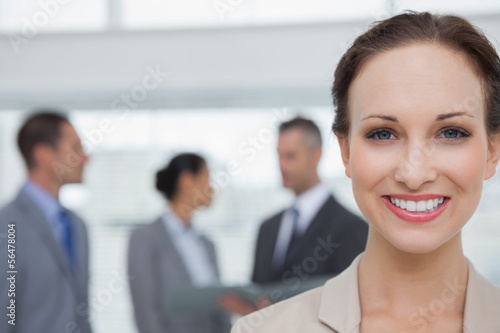 Photo: Cheerful businesswoman smiling at camera Cheerful businesswoman smiling at camera