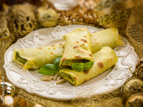 Photo: pesto crepes over golden christmas table pesto crepes over golden christmas table