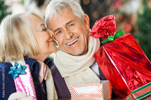 Photo: Woman About To Kiss Man Holding Christmas Presents Woman About To Kiss Man Holding Christmas Presents