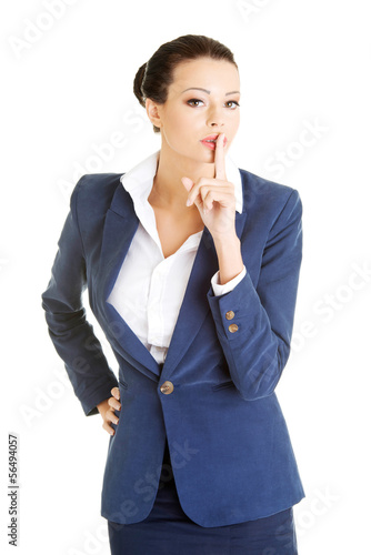 Photo: Attractive business woman with finger on lips Attractive business woman with finger on lips