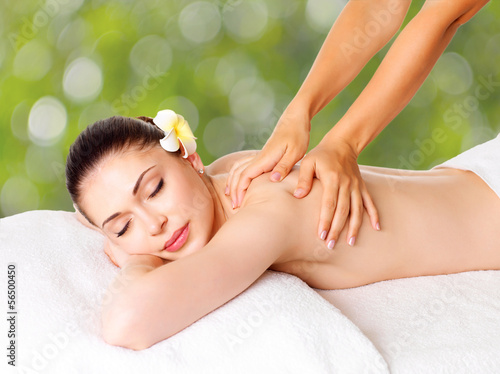 Photo: Woman having massage of body in spa salon Woman having massage of body in spa salon