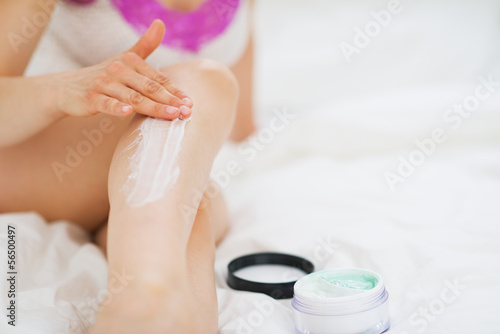 Photo: Closeup on woman applying creme on leg Closeup on woman applying creme on leg