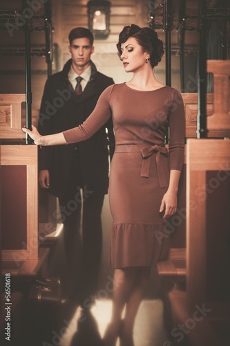 Photo: Beautiful vintage style couple inside retro train coach Beautiful vintage style couple inside retro train coach
