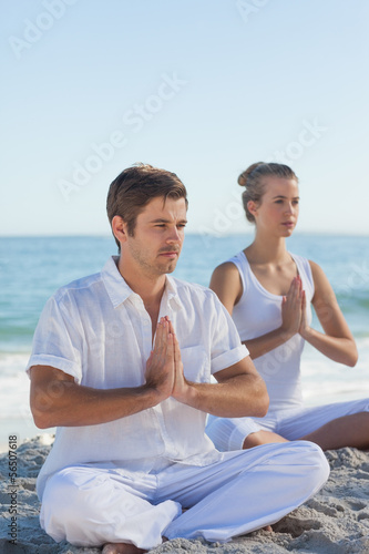 Photo: Man and woman practicing yoga Man and woman practicing yoga