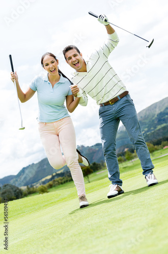 Photo: Happy couple playing golf Happy couple playing golf