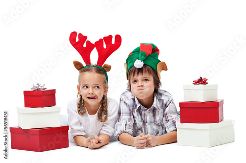 Photo: Christmas kids with presents and funny hats - isolated Christmas kids with presents and funny hats - isolated