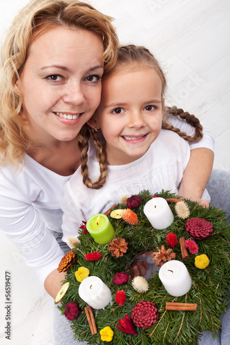 Photo: Woman and little girl with advent wreath Woman and little girl with advent wreath