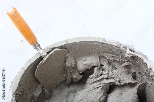 Photo: dirty trowel and bucket on building site dirty trowel and bucket on building site
