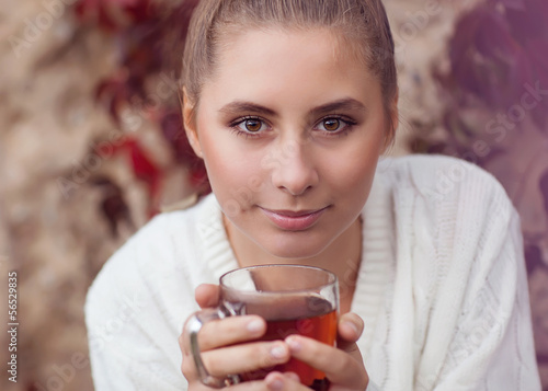 Photo: Girl enjoying a large cup of freshly brewed hot tea Girl enjoying a large cup of freshly brewed hot tea