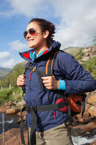 Photo: Brunette wearing rain jacket and sunglasses smiling Brunette wearing rain jacket and sunglasses smiling