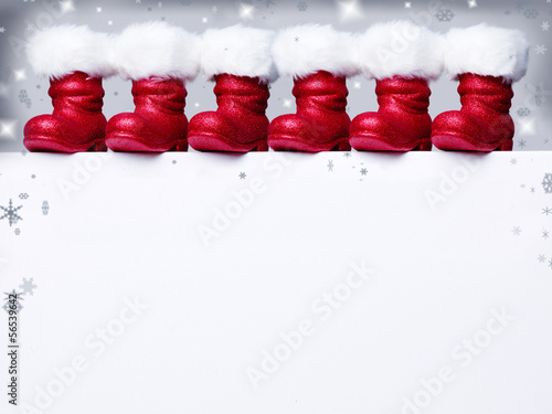 Photo: Voucher for christmas with many Santa Claus boots Voucher for christmas with many Santa Claus boots
