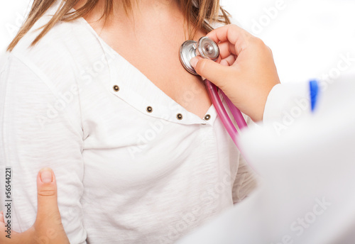Photo: a doctor checking the heart rate of a girl a doctor checking the heart rate of a girl