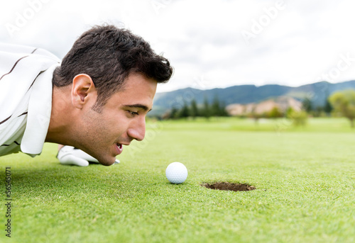 Photo: Golf player blowing the ball Golf player blowing the ball