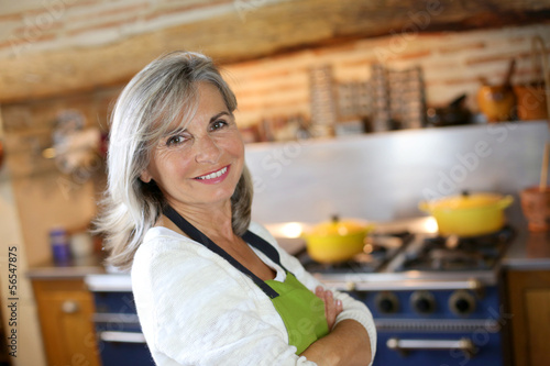 Photo: Portrait of senior woman in home kitchen Portrait of senior woman in home kitchen