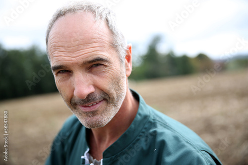 Photo: Portrait of cheerful farmer in agricultural field Portrait of cheerful farmer in agricultural field