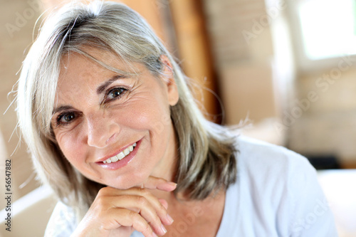 Photo: Portrait of senior woman relaxing at home Portrait of senior woman relaxing at home