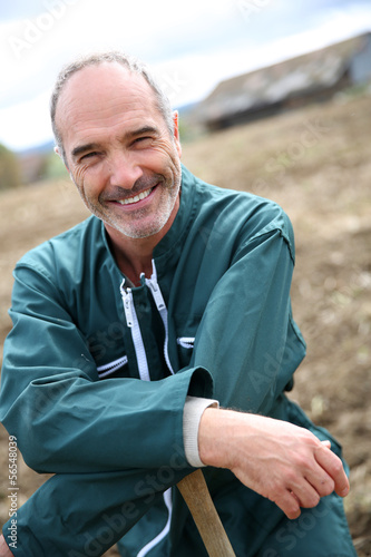 Photo: Portrait of cheerful farmer in agricultural field Portrait of cheerful farmer in agricultural field