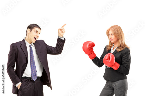 Photo: Angry businessman having an argument with a businesswoman Angry businessman having an argument with a businesswoman