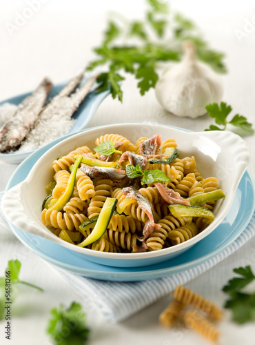 Photo: fusilli with anchovies and zucchinis, selective focus fusilli with anchovies and zucchinis, selective focus
