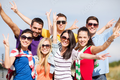 Photo: group of friends having fun on the beach group of friends having fun on the beach