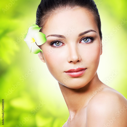 Photo: Closeup healthy face of young woman Closeup healthy face of young woman