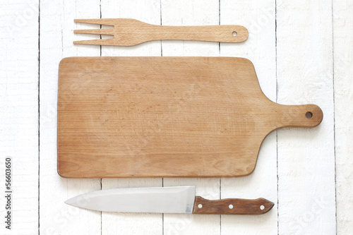 Photo: Empty cutting board on white planks food background concept Empty cutting board on white planks food background concept