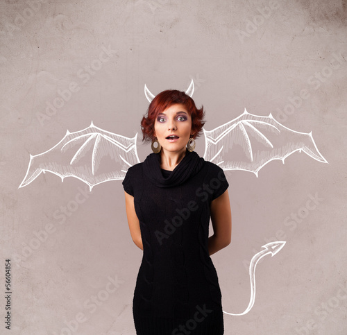 Photo: Young girl with devil horns and wings drawing Young girl with devil horns and wings drawing