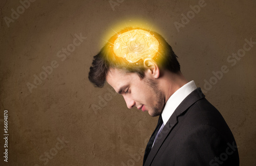 Photo: Young man thinking with glowing brain illustration Young man thinking with glowing brain illustration