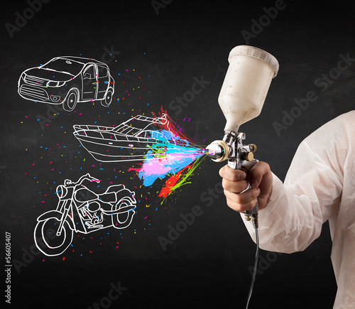 Photo: Man with airbrush spray paint with car, boat and motorcycle draw Man with airbrush spray paint with car, boat and motorcycle draw