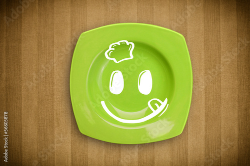 Photo: Happy smiley cartoon face on colorful dish plate Happy smiley cartoon face on colorful dish plate