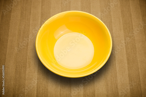 Photo: Colorful empty plate on grungy background table Colorful empty plate on grungy background table