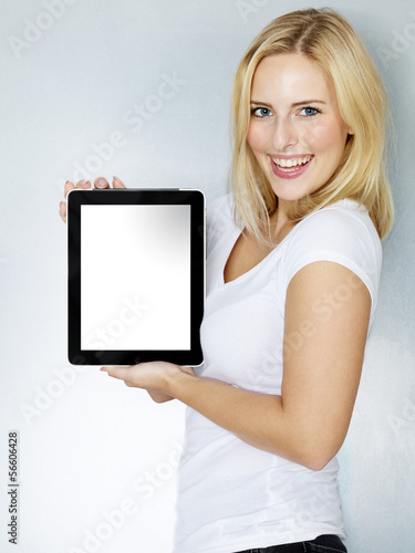Photo: Woman presenting her tablet pc with copyspace Woman presenting her tablet pc with copyspace