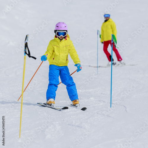 Photo: Skiing, skiers on ski run - child skiing downhill Skiing, skiers on ski run - child skiing downhill