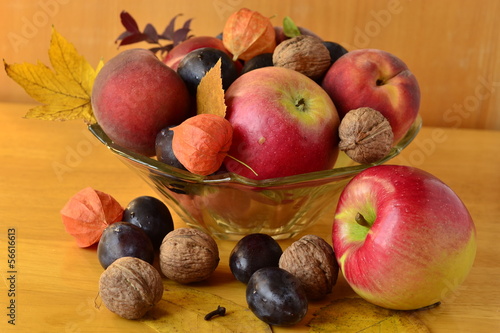 Photo: Autumn fruit in a vase on a wooden table Autumn fruit in a vase on a wooden table