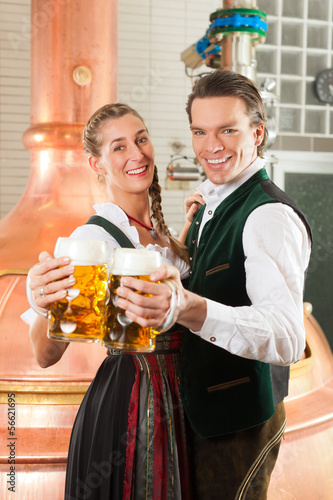 Photo: Man and woman with beer glass in brewery Man and woman with beer glass in brewery