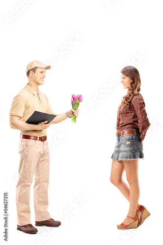 Photo: Full length portrait of a delivery boy holding a bunch of flower Full length portrait of a delivery boy holding a bunch of flower
