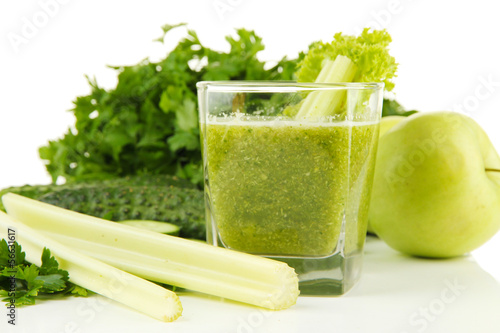 Photo: Glass of green vegetable juice and vegetables close up Glass of green vegetable juice and vegetables close up