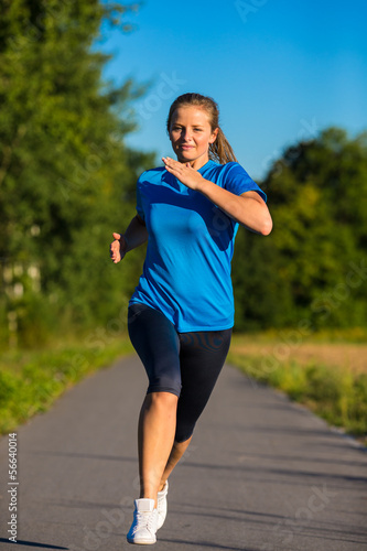 Photo: Urban leisure - woman running outdoor Urban leisure - woman running outdoor
