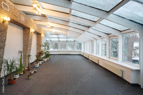 Photo: Empty conservatory with small number of plants and glass ceiling Empty conservatory with small number of plants and glass ceiling