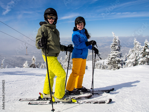 Photo: Teenage girl and boy skiing Teenage girl and boy skiing
