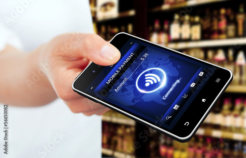 Photo: hand holding mobile phone with mobile payment screen hand holding mobile phone with mobile payment screen