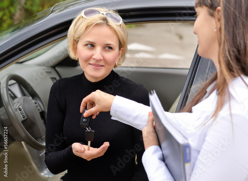 Photo: Saleslady handing over the keys Saleslady handing over the keys