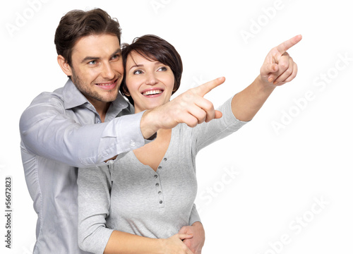 Photo: happy couple looking and pointing into the distance happy couple looking and pointing into the distance